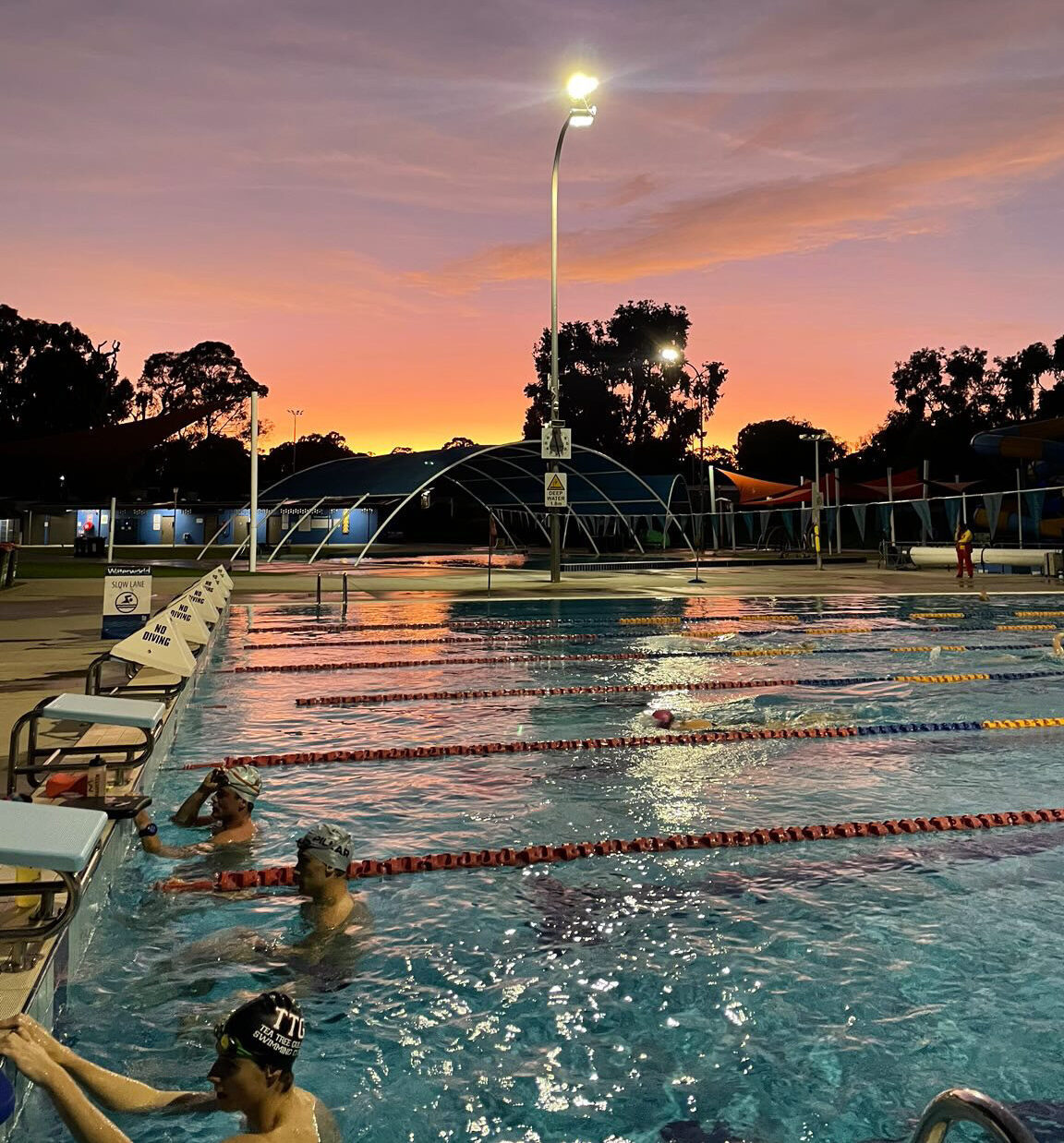 Sunrise over swimmers